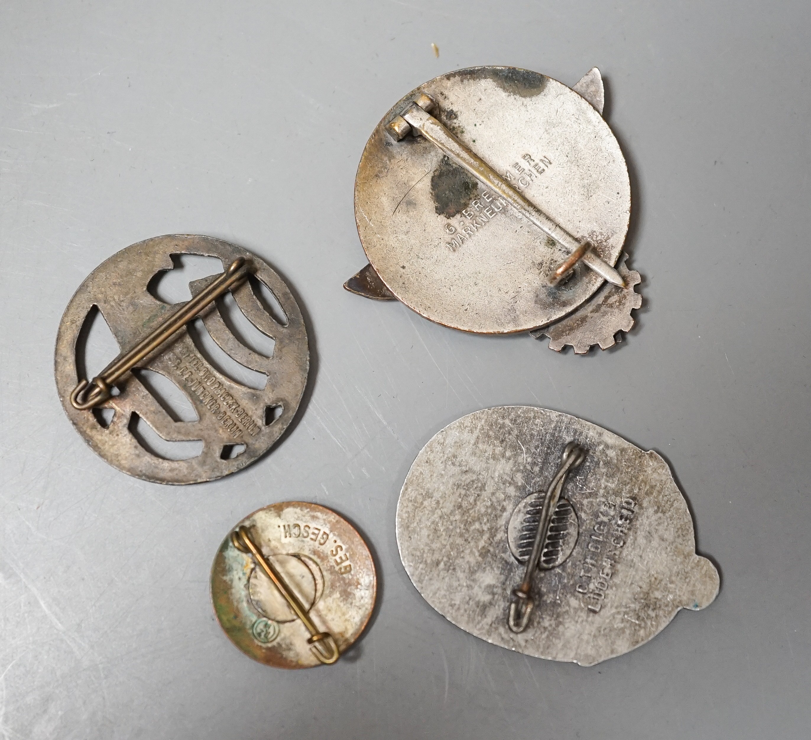 A WW2 German Hitler Youth Gausieger badge, a Wehrmachtgefolge badge for civilian workers, a Tag der Arbeit badge and an Adolf Hitler 1933 enamelled badge (4)